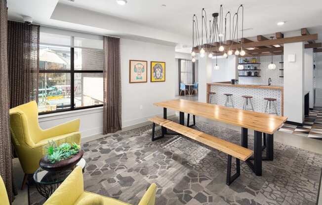 a dining room with a wooden table and yellow chairs