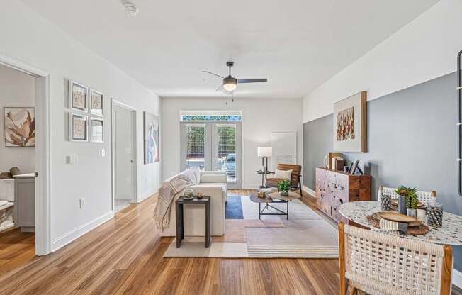A living room with a white ceiling and a fan.
