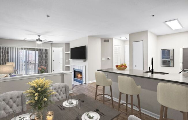 A modern kitchen with a dining table set for two.