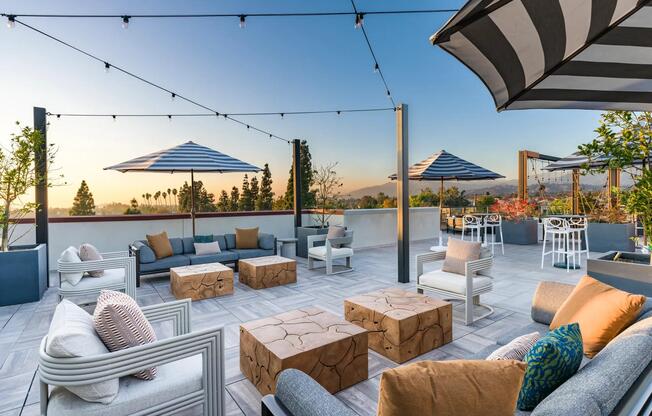 Experience the rooftop deck at Modera Pomona with stunning views, cozy seating, and the perfect space to relax or entertain.