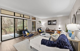 a living room with a white couch and a tv