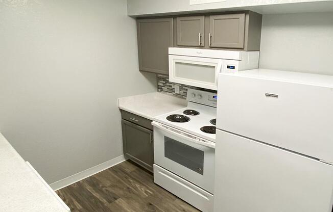 a stove top oven sitting inside of a kitchen