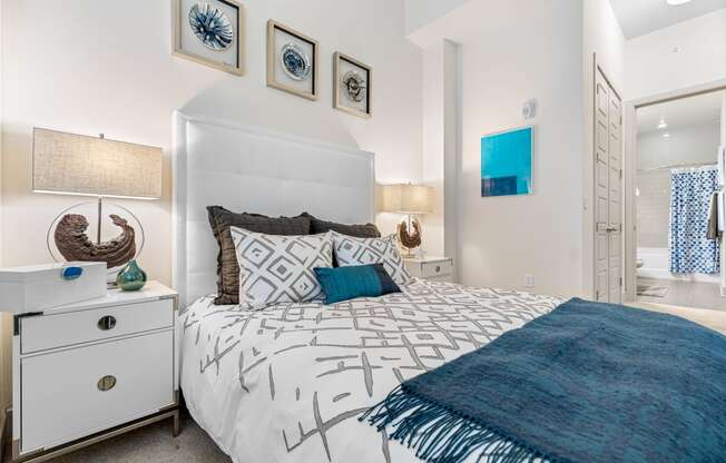 a bedroom with a white bed and a blue blanket