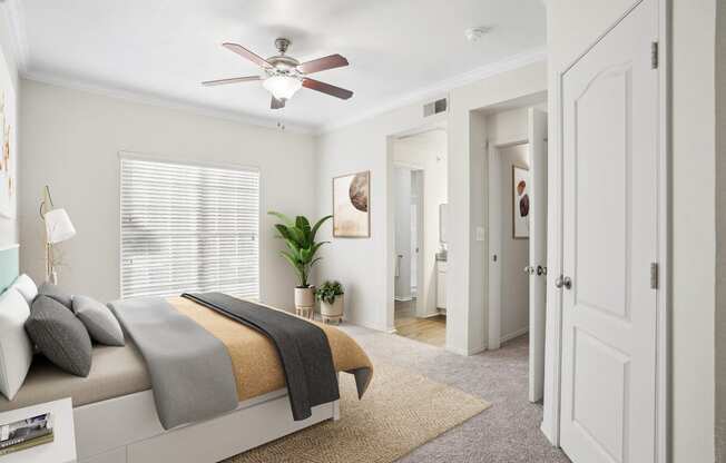 a bedroom with a bed and a ceiling fan