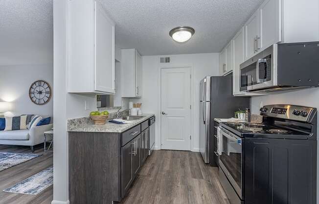 an open kitchen with black appliances and white cabinets