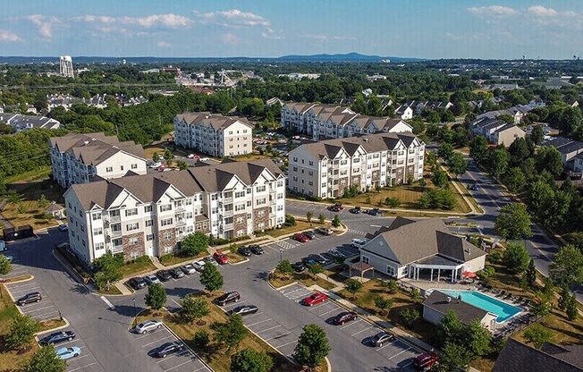 an aerial view of apartment buildings in a parking lot