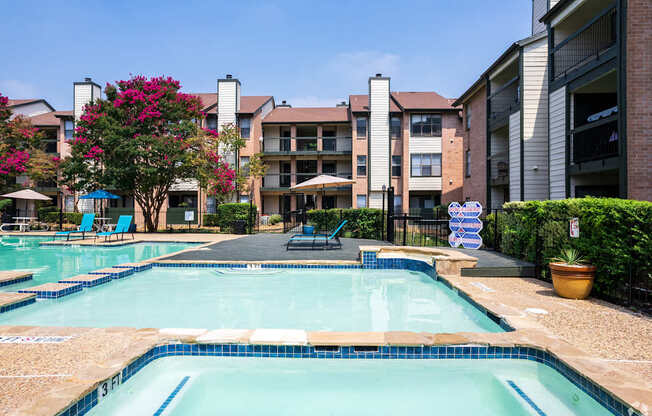 A swimming pool surrounded by apartment buildings.