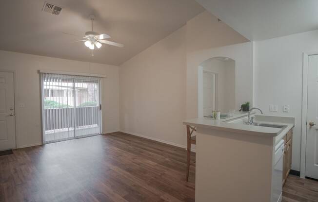 an empty living room and kitchen in an empty house