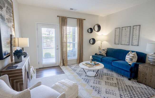 A living room with a blue couch and a coffee table.