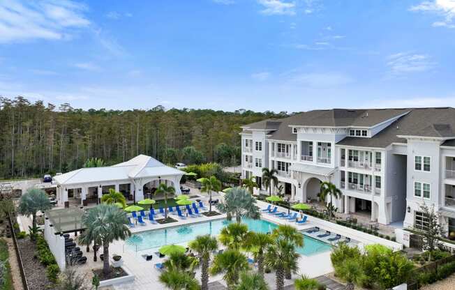 an aerial view of a large resort with a swimming pool