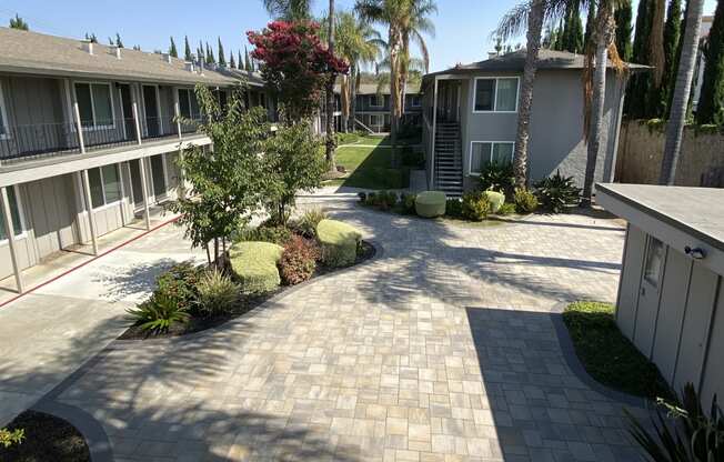 a view of the courtyard of a condo building with palm trees