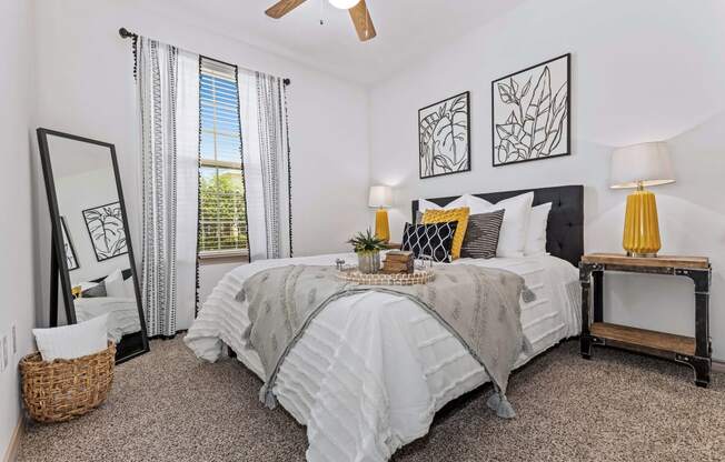 a bedroom with a large bed and a window