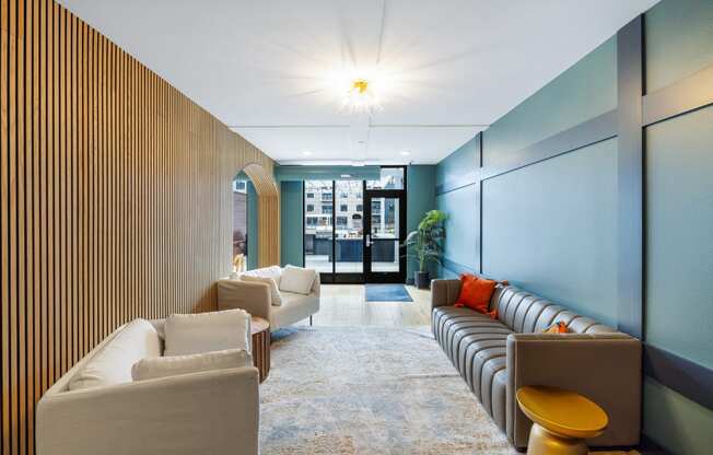 a lobby with couches and chairs and a wall with a door at EagleRidge Plaza Residences, Fargo, ND, 58104