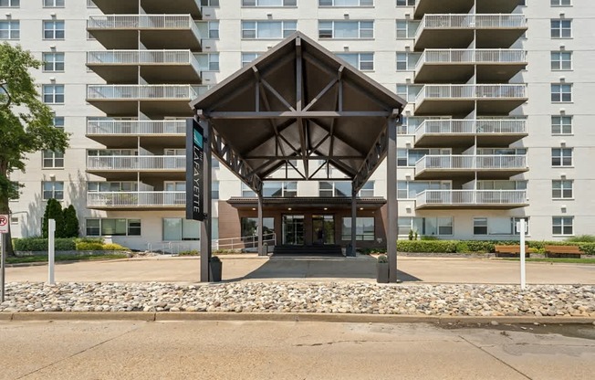 the entrance to an apartment building with awning in front of an empty street at The Lafayette Apartments, Colonial Place, Norfolk