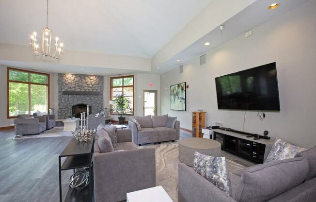 Laurel East End Apartments in Golden Valley, MN photo of a living room with couches and a tv and a fireplace