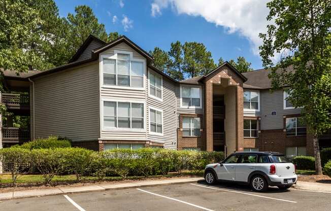 an apartment building with a car parked in front of it