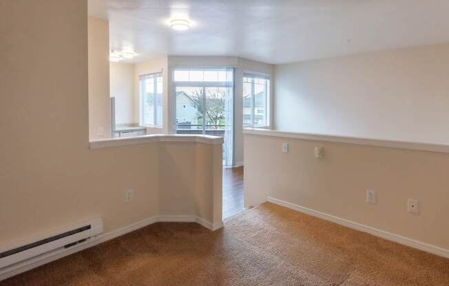 A room with a window and a door leading to another room.