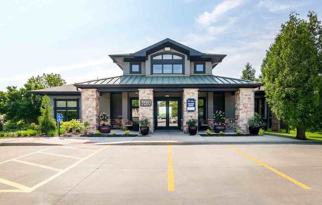 A building with a green roof and stone pillars in front of it.