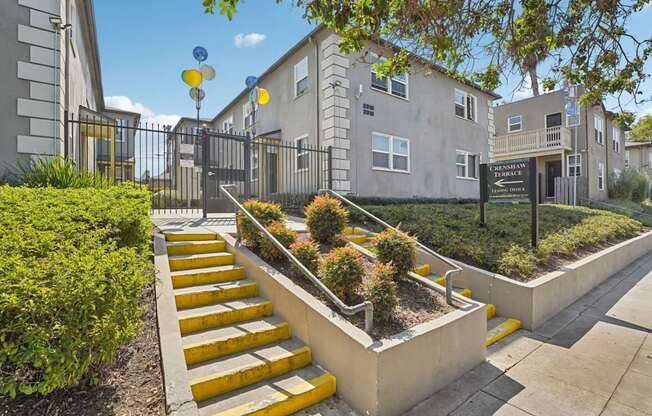 A set of yellow steps lead up to a building entrance.