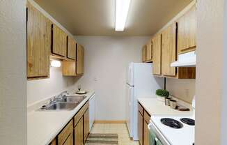 Full Kitchen with Wood Cabinets, White Appliances and Laminate Countertops