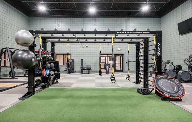 a workout room with weights and other equipment in a gym