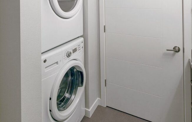 The Wilmore Laundry room with stacked washer and dryer