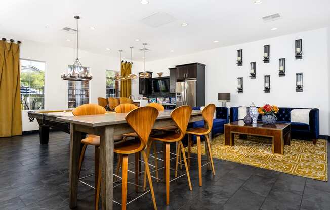 a dining area with a table and chairs and a living room with a television