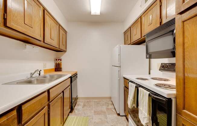 Kitchen in the one-bedroom model unit at Olde English Village, featuring spacious countertops and practical appliances.