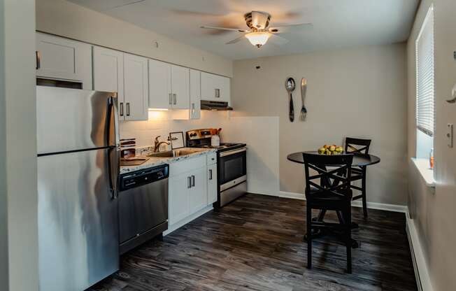 a kitchen with white cabinets and stainless steel appliances at Glen Hollow, Croydon, Pennsylvania