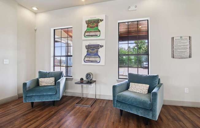 Two chairs and a table are in a room with a window.