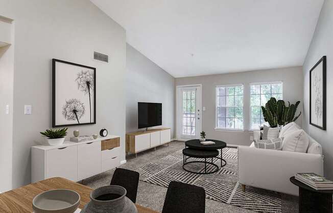 A modern living room with a dining table set for two.