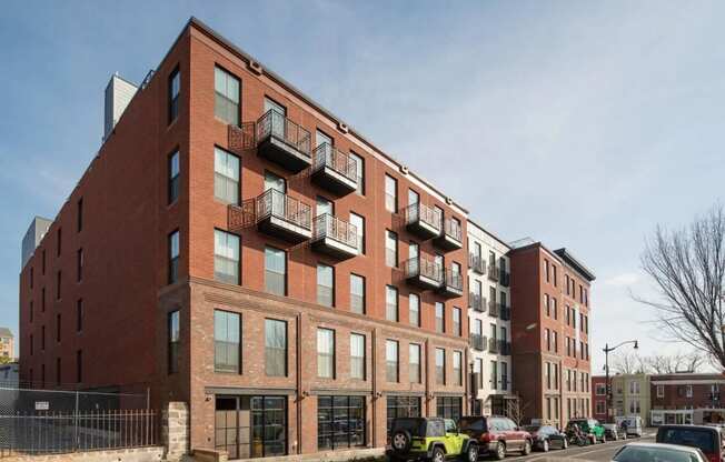 a brick building with a lot of cars parked in front of it