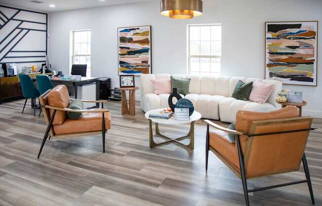 A living room with a white couch and brown chairs at Evergreen Luxury Apartments, Merrillville, Indiana