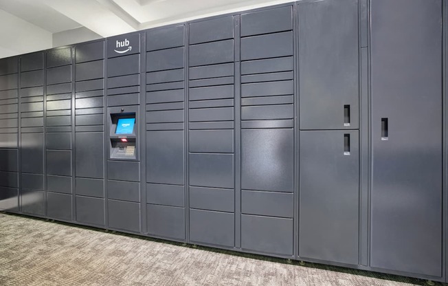A row of dark grey lockers with a sign that says "hub" on the top left.
