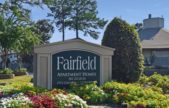 sign for fairfield apartments homes in front of flowers