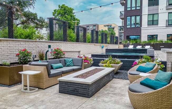 an outdoor patio with couches and a firepit