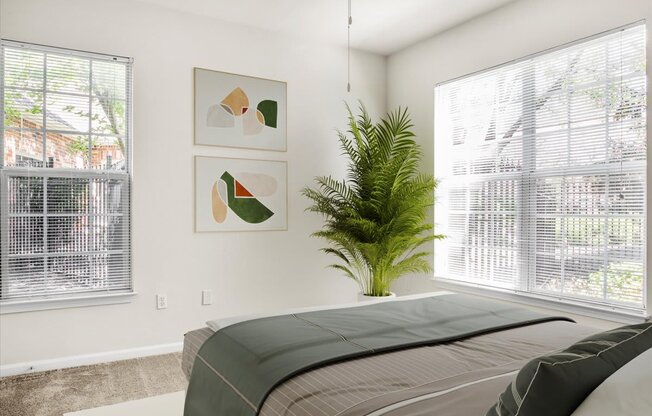 a bedroom with a bed and a potted plant and two windows