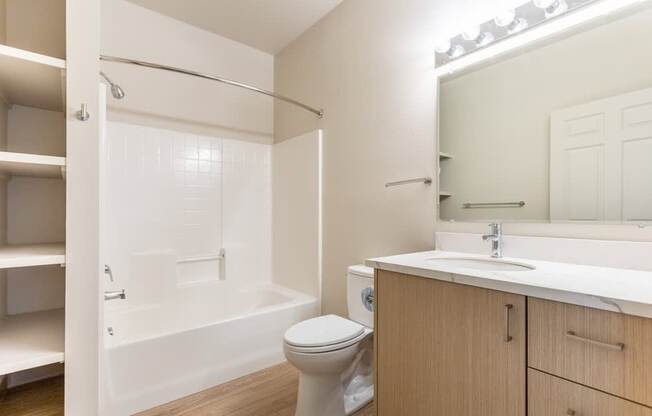 A white bathroom with a toilet, sink, and bathtub at Wilsonville Summit Apartments, Oregon, 97070