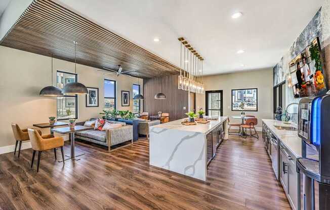 Luxurious open-plan clubroom at Summit on Boulder Apartments featuring stylish kitchen island, elegant dining area, and cozy seating with modern decor.