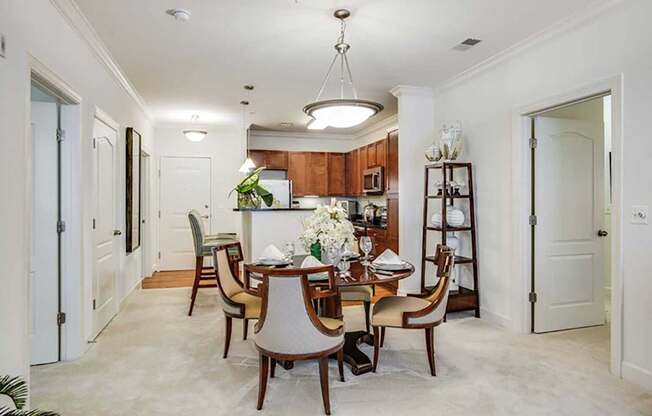 a dining room and kitchen with a table and chairs