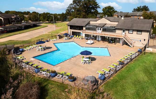 arial view of a pool with a house in the background