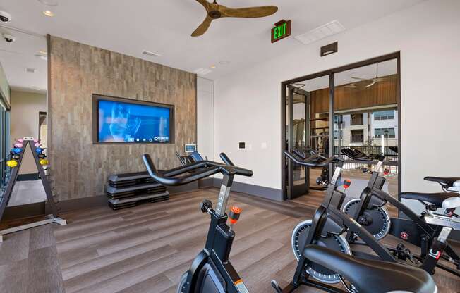 workout room with amenities at ironridge at hill country village apartments