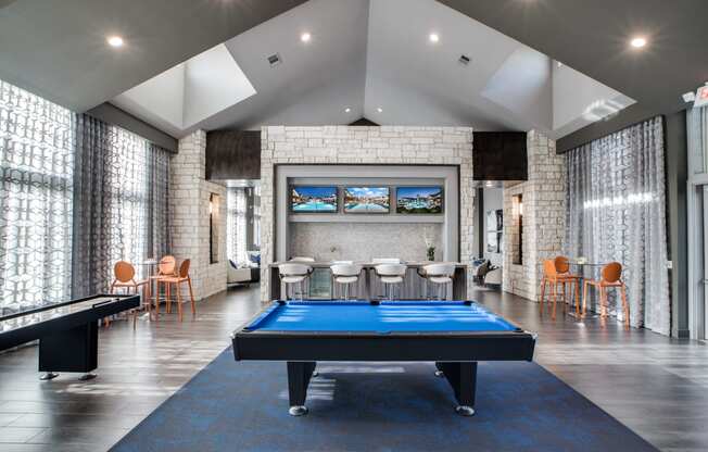 a games room with a pool table and a foosball table