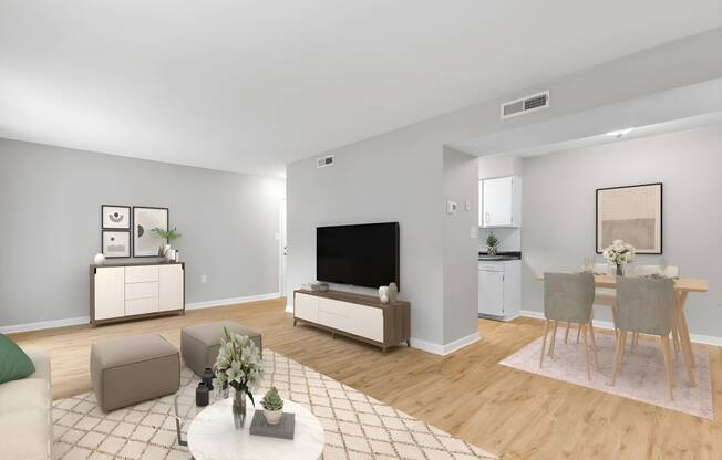 a living room with a table and chairs and a television