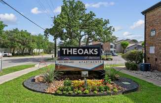 The entrance sign to The Oaks of Denton Apartments in Denton, TX