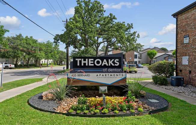 The entrance sign to The Oaks of Denton Apartments in Denton, TX