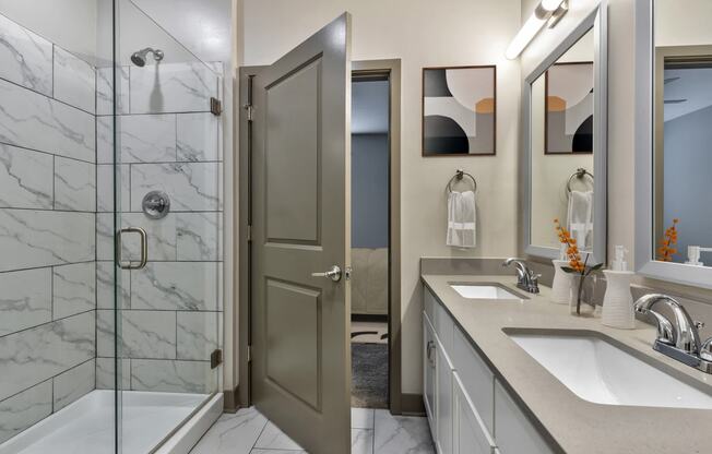 a bathroom with a shower and a sink and a mirror