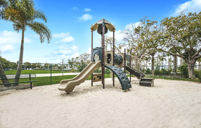 A playground with a slide and a sandbox.