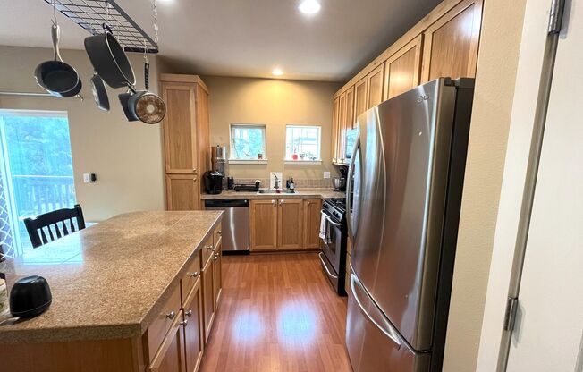Charming 2-Bed Townhome in Sherwood with Pool Access, Garage, and Vaulted Ceilings!