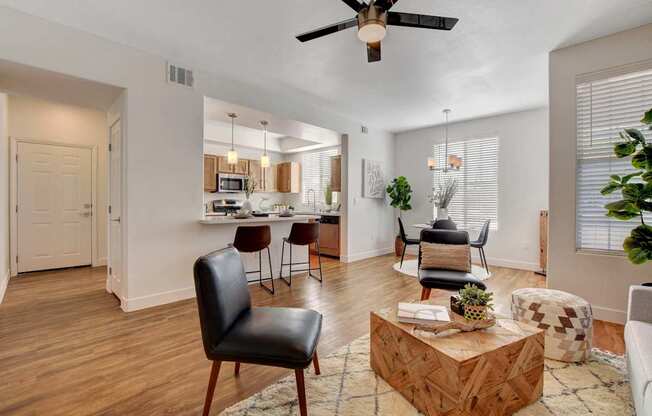 A living room with a black leather chair and a wooden coffee table.